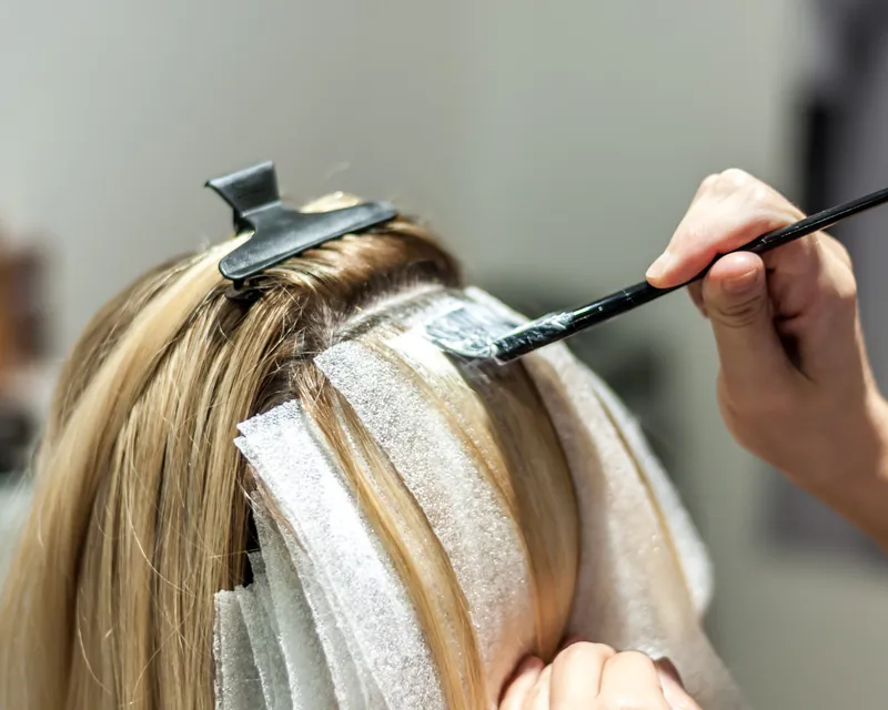 Colorist applying foil highlights at New Image Hair Salon on Cape Cod